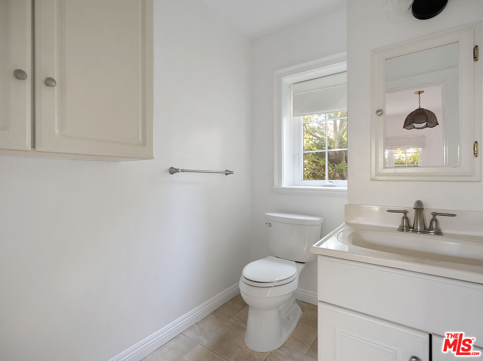 13161 Addison Street Sherman Oaks, CA 91423 - Photo 29 of 34 a bathroom with a toilet sink and mirror