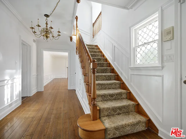 a view of entryway and hall with wooden floor