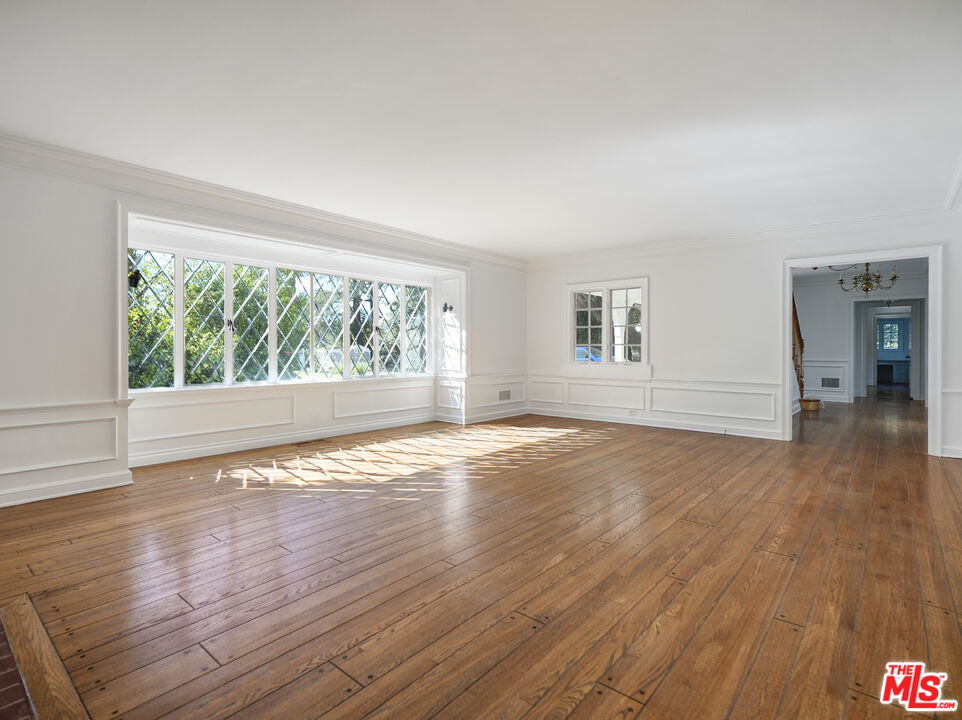 13161 Addison Street Sherman Oaks, CA 91423 - Photo 7 of 34 a view of empty room with wooden floor and fan