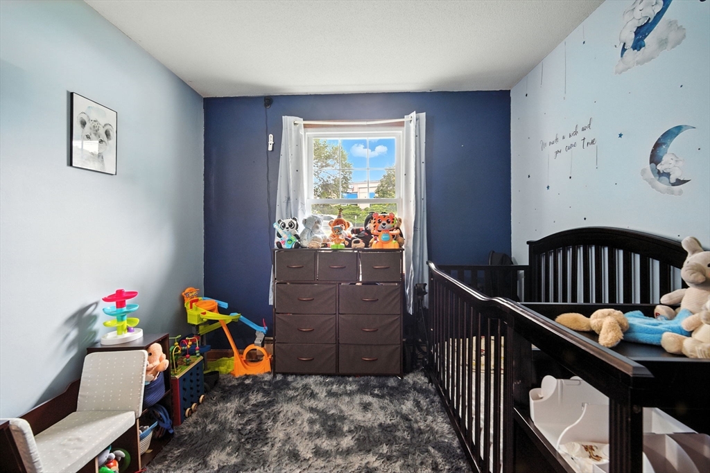 263 Cooley Street Springfield, MA 01128 - Photo 11 of 20 a bedroom with furniture and a window