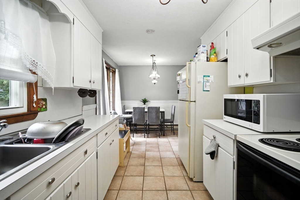 263 Cooley Street Springfield, MA 01128 - Photo 15 of 20 a kitchen with a sink cabinets and stainless steel appliances