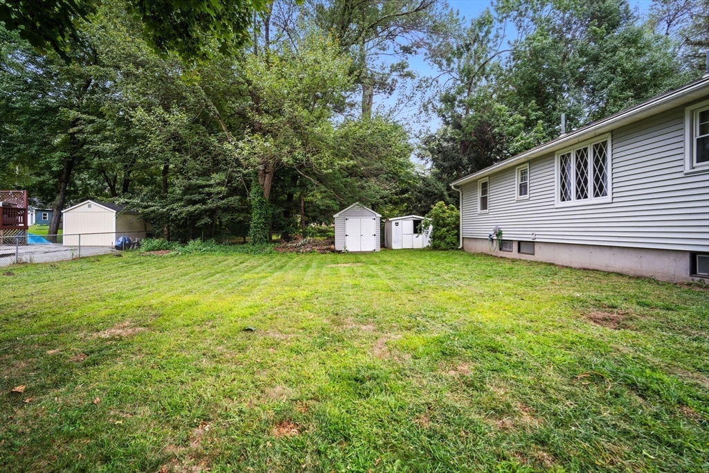 263 Cooley Street Springfield, MA 01128 - Photo 3 of 20 a view of a house with backyard and tree