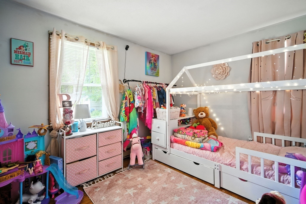 263 Cooley Street Springfield, MA 01128 - Photo 9 of 20 a living room with furniture and a baby crib