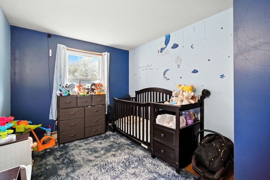 263 Cooley Street Springfield, MA 01128 - Photo 10 of 20 a bedroom with a bed and a window
