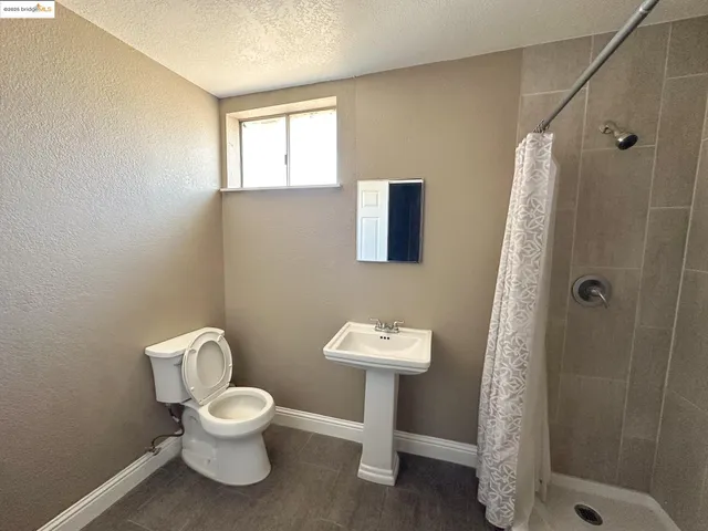 a white toilet sitting next to a bathroom sink