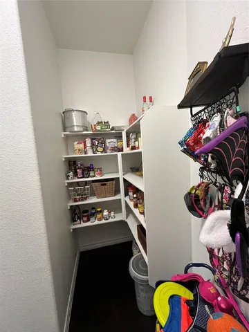 a bedroom with bed and a chandelier