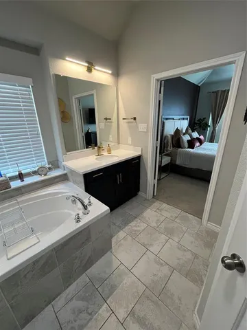 a bathroom with a sink a toilet and mirror
