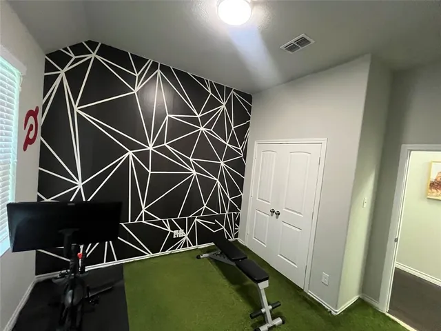 a room with gym equipment and a mirror