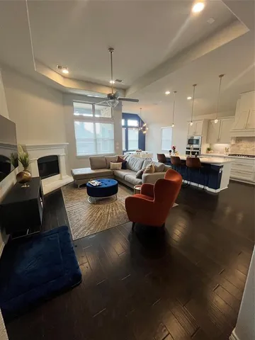 a living room with furniture a fireplace and a flat screen tv