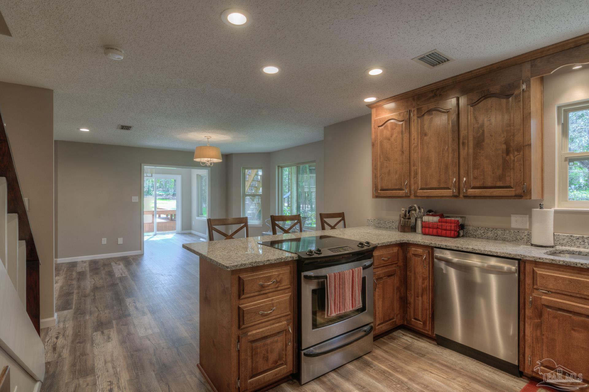 4917 Shell Road Milton, FL 32570 - Photo 14 of 49 a kitchen with a sink stove and cabinets