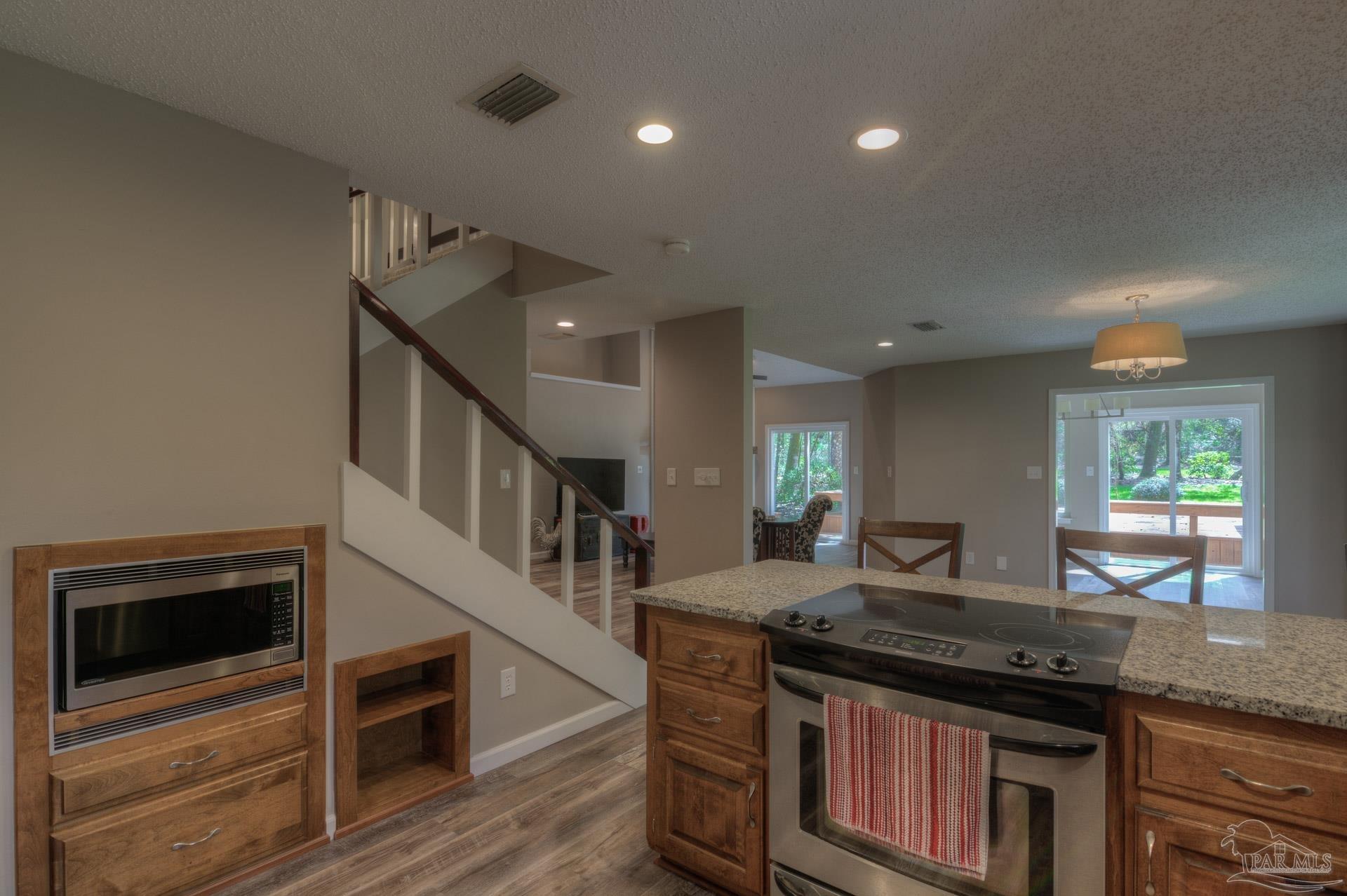 4917 Shell Road Milton, FL 32570 - Photo 15 of 49 a kitchen with granite countertop a stove and a sink