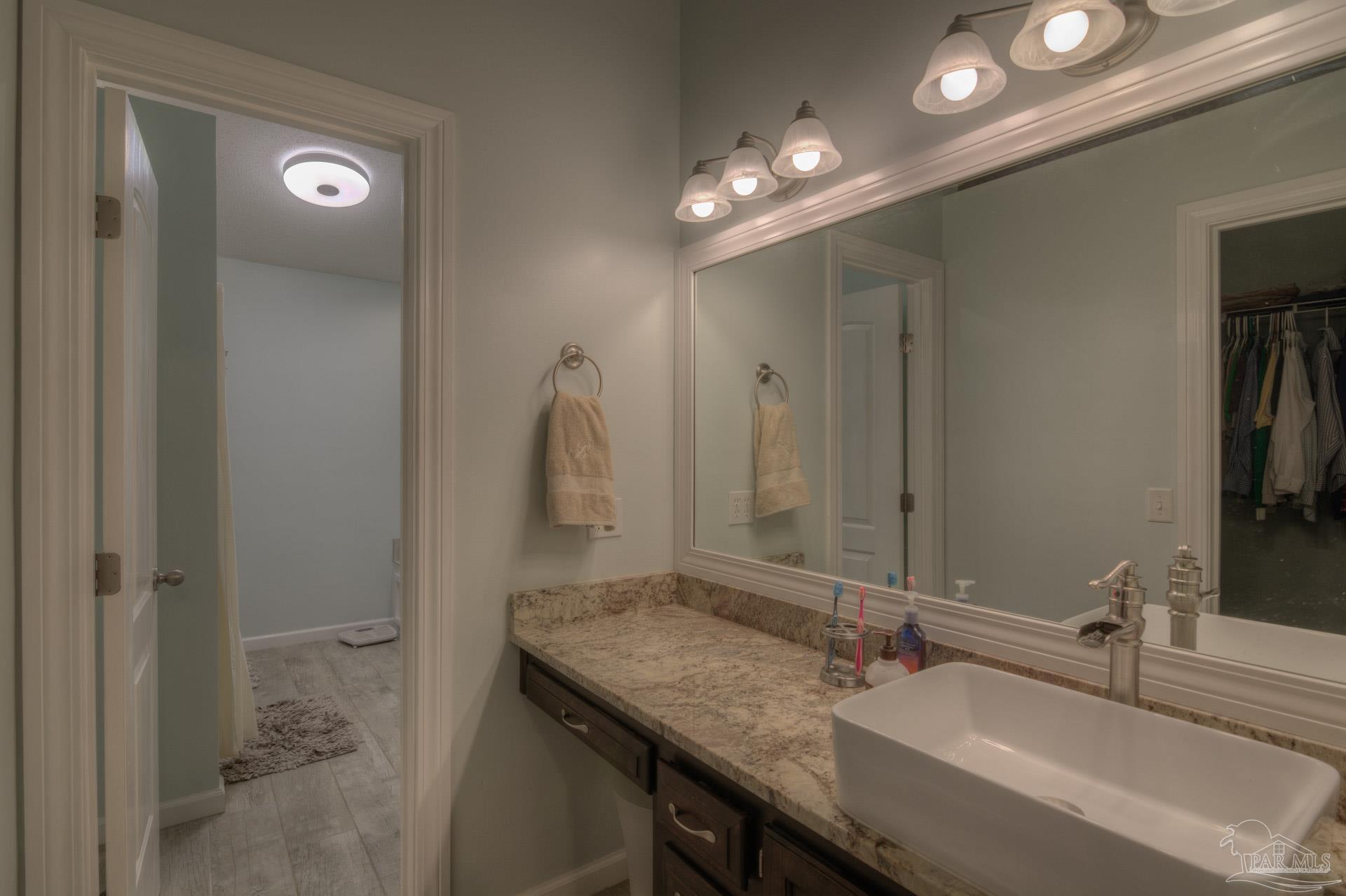 4917 Shell Road Milton, FL 32570 - Photo 28 of 49 a bathroom with a sink vanity granite and a mirror
