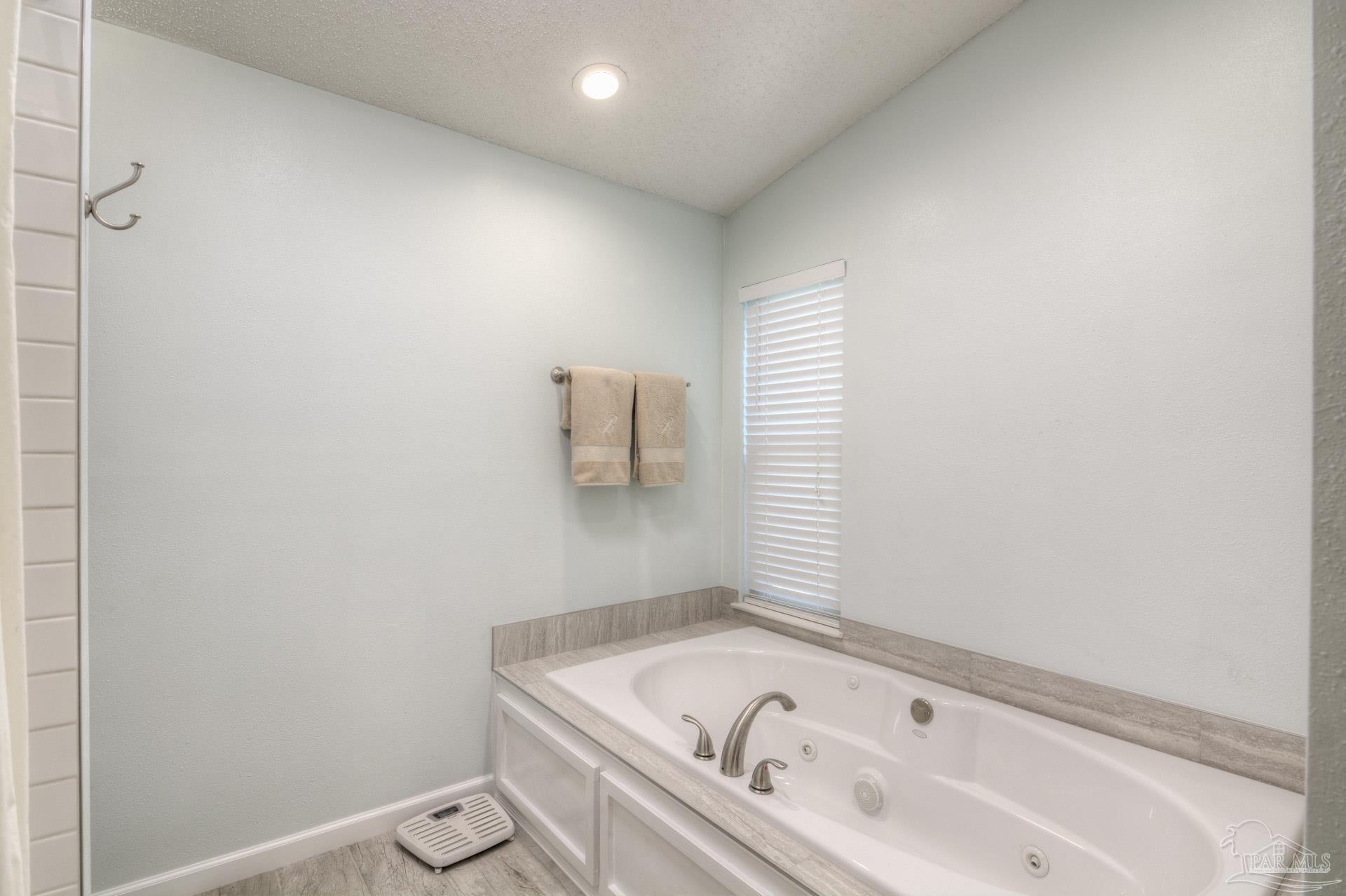4917 Shell Road Milton, FL 32570 - Photo 29 of 49 a bathroom with a bathtub and window