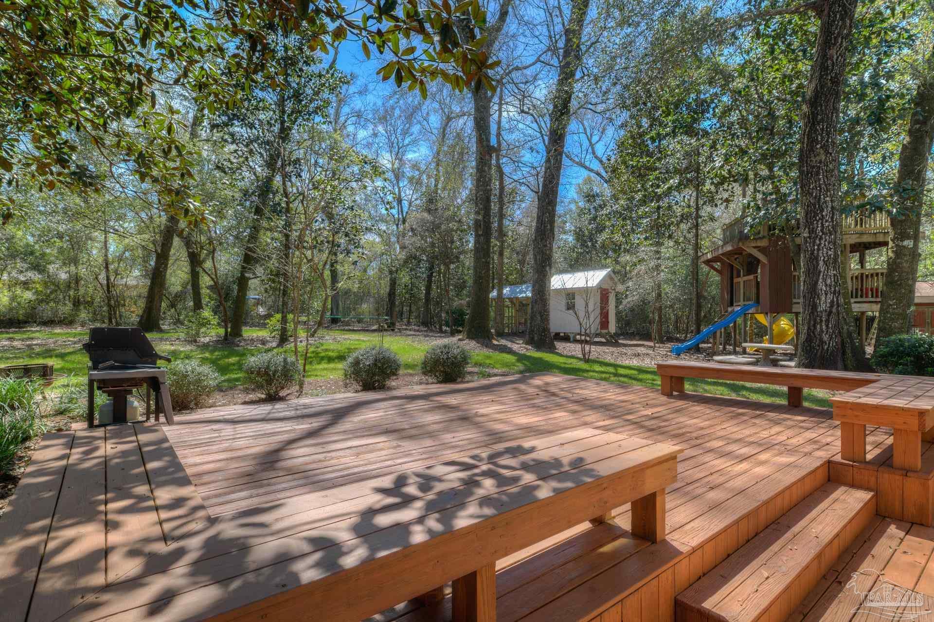 4917 Shell Road Milton, FL 32570 - Photo 35 of 49 a view of a park with swings and slides