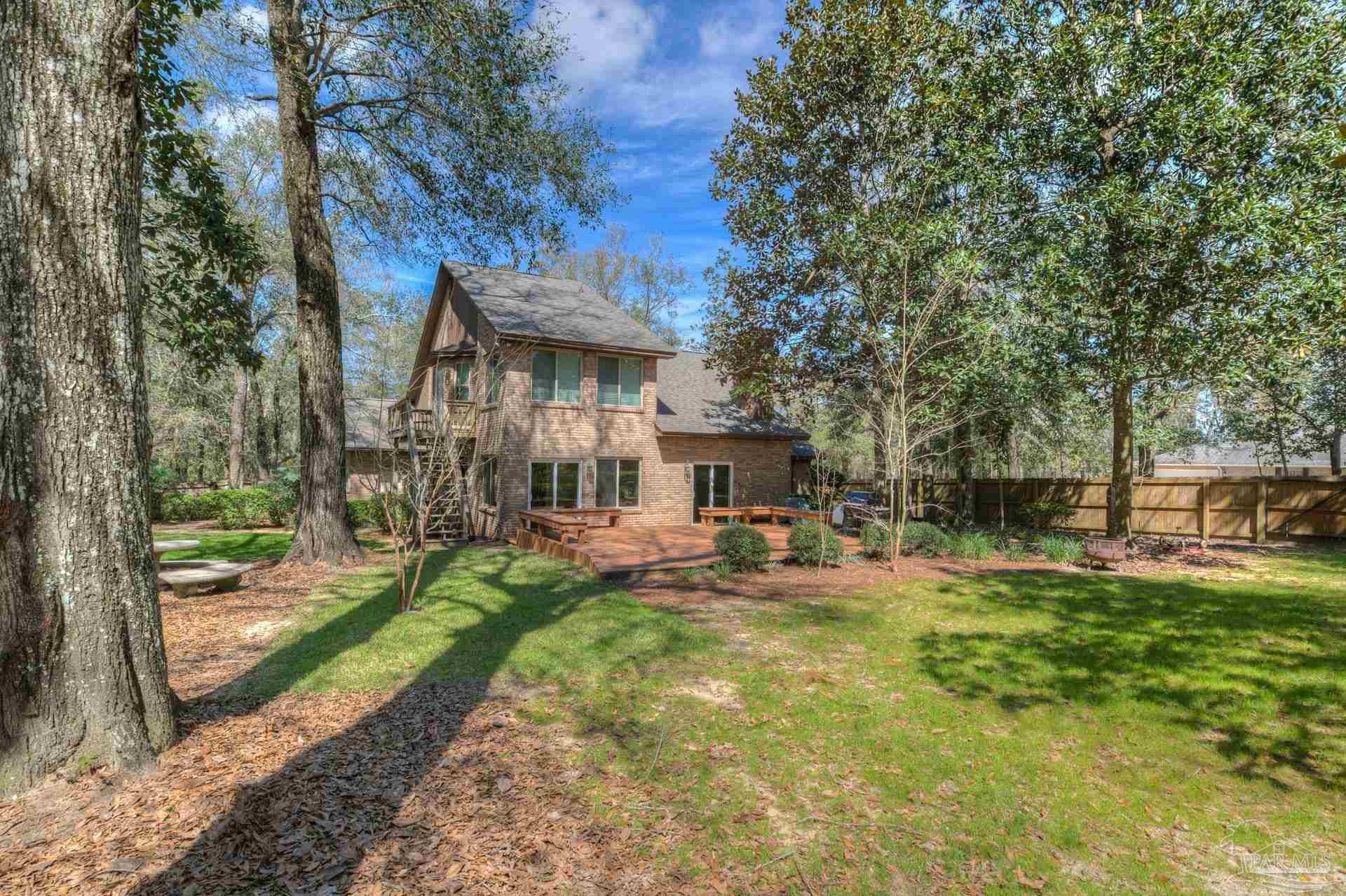 4917 Shell Road Milton, FL 32570 - Photo 38 of 49 a view of a house with backyard porch and sitting area