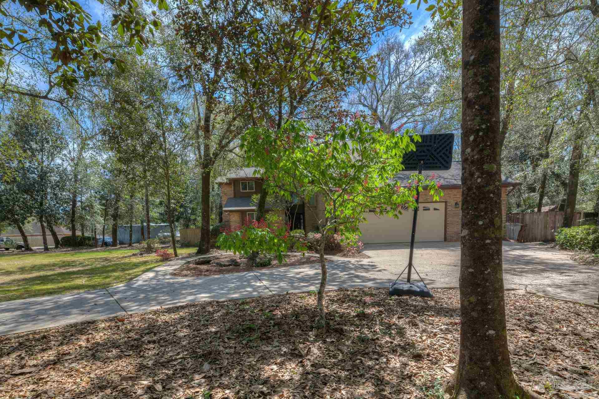 4917 Shell Road Milton, FL 32570 - Photo 49 of 49 a backyard of a house with trees