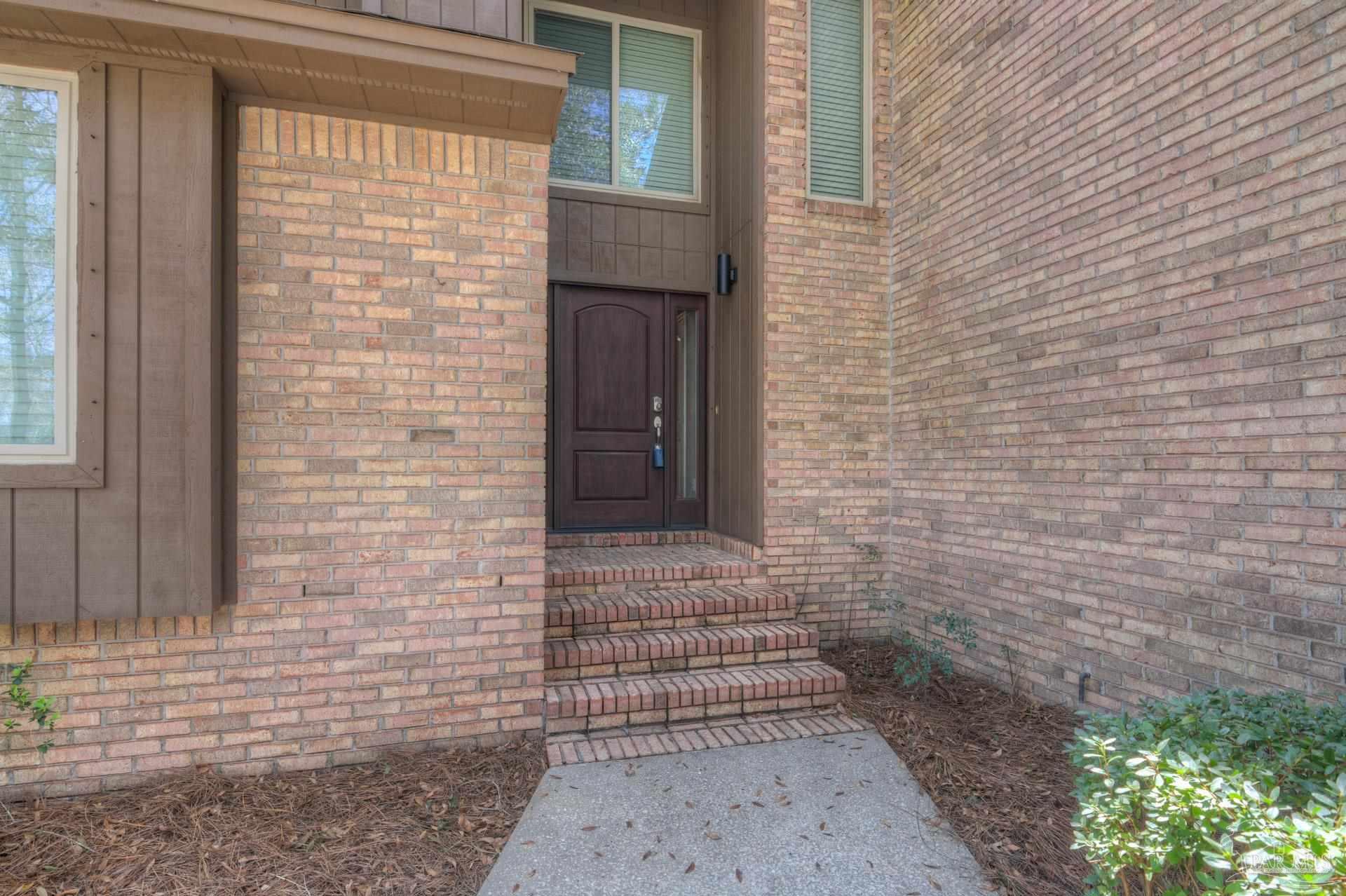 4917 Shell Road Milton, FL 32570 - Photo 6 of 49 a brick house with a small yard