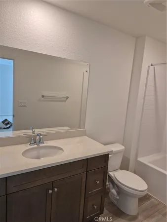 a bathroom with a sink vanity mirror and toilet