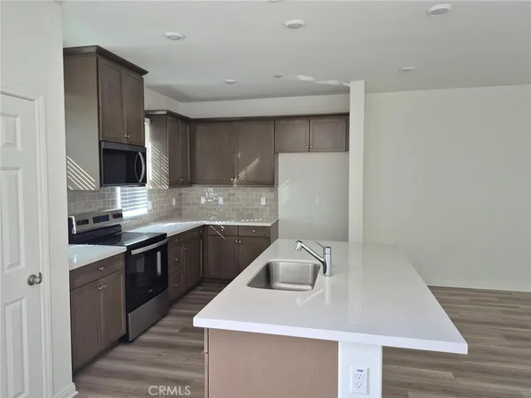 a kitchen with a sink a stove and refrigerator