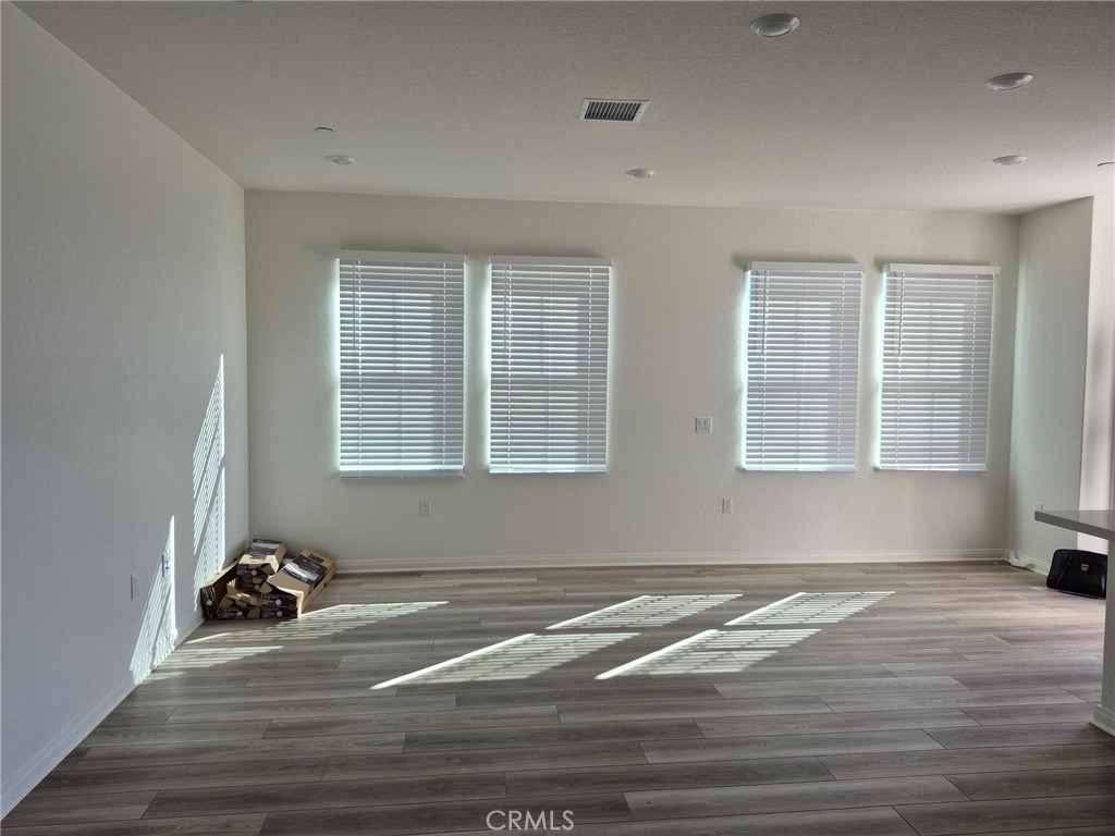 4233 East Rincon Street Ontario, CA 91761 - Photo 3 of 20 a view of a livingroom with wooden floor and a window