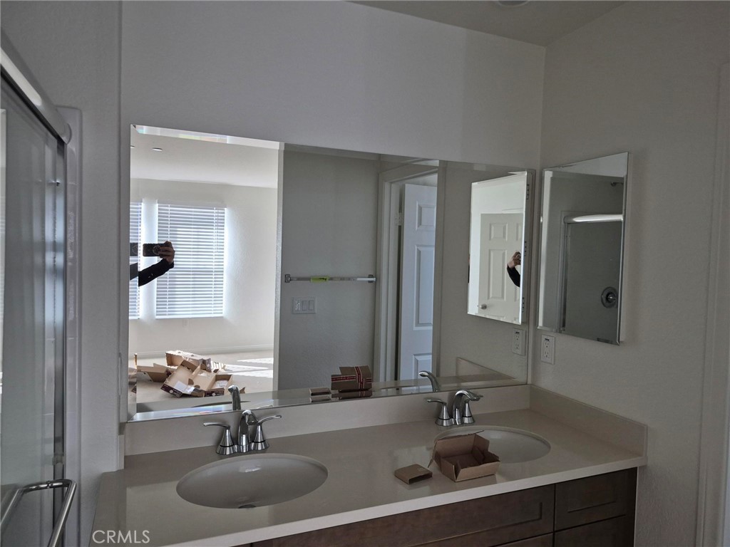 4233 East Rincon Street Ontario, CA 91761 - Photo 9 of 20 a bathroom with a sink and a mirror