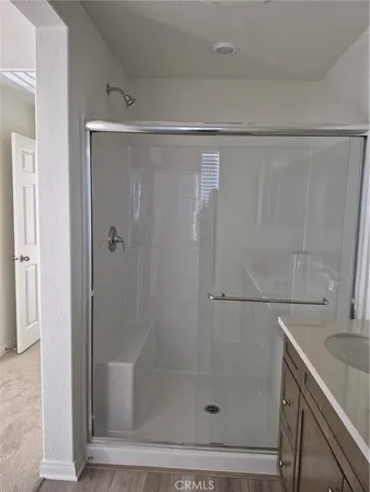 a bathroom with a shower and a sink