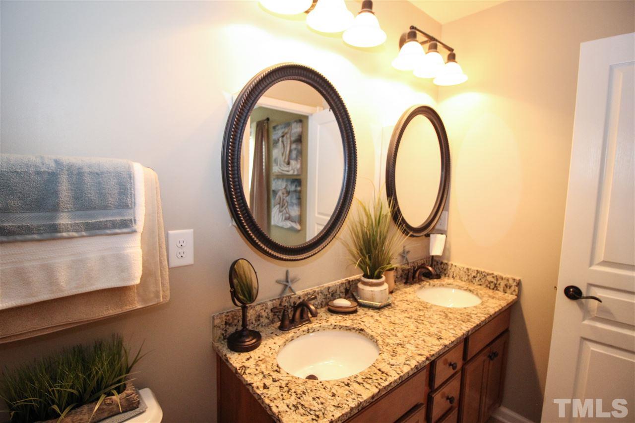 2901 Berkeley Springs Place Raleigh, NC 27616 - Photo 15 of 24 a bathroom with a sink and a mirror