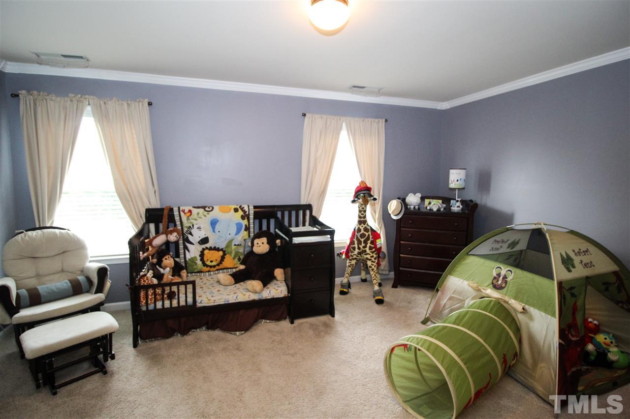 2901 Berkeley Springs Place Raleigh, NC 27616 - Photo 17 of 24 a bedroom with bed and a couch