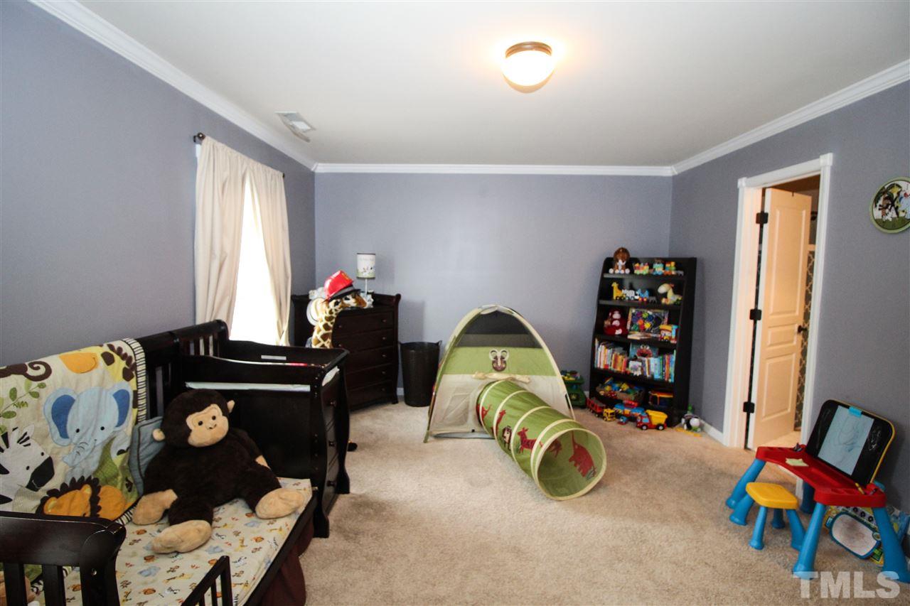 2901 Berkeley Springs Place Raleigh, NC 27616 - Photo 18 of 24 a bedroom with furniture and a window