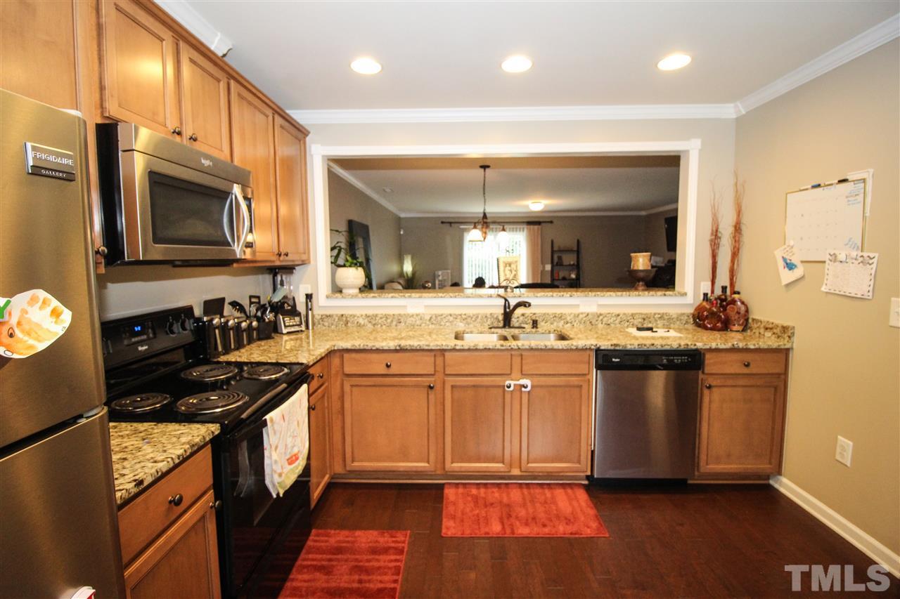 2901 Berkeley Springs Place Raleigh, NC 27616 - Photo 4 of 24 a kitchen with stainless steel appliances granite countertop a stove a sink and a microwave