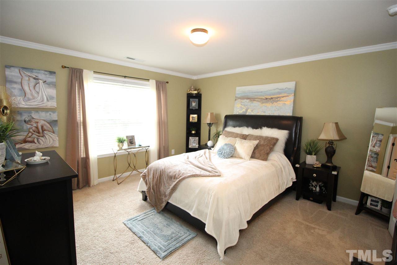 2901 Berkeley Springs Place Raleigh, NC 27616 - Photo 9 of 24 a large bed sitting in a bedroom next to a window