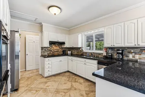 a spacious bedroom with a bed and a flat screen tv