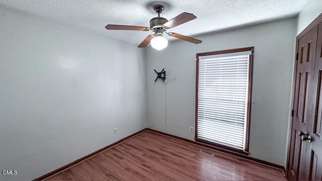 104 Baldwin Circle Garner, NC 27529 - Photo 14 of 20 a view of an empty room with wooden floor and a window