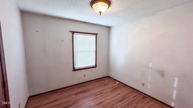 104 Baldwin Circle Garner, NC 27529 - Photo 16 of 20 an empty room with wooden floor and windows
