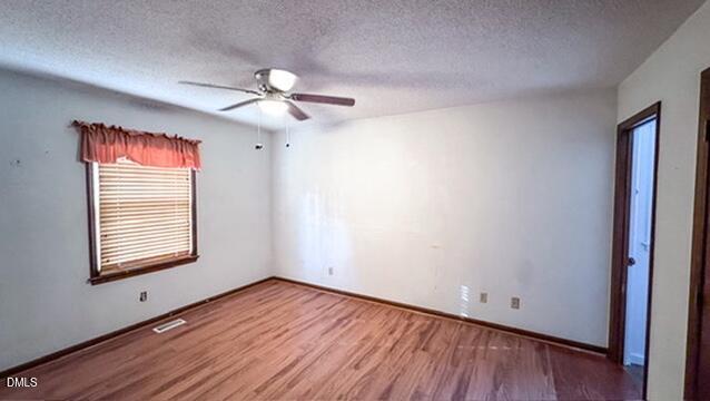 104 Baldwin Circle Garner, NC 27529 - Photo 18 of 20 a view of empty room with wooden floor and fan