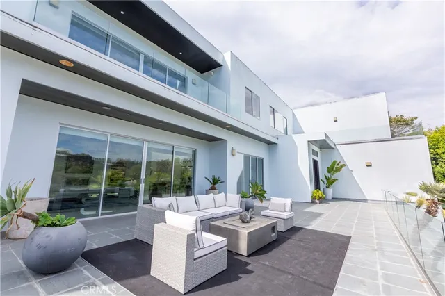 a view of the patio with couches and potted plants
