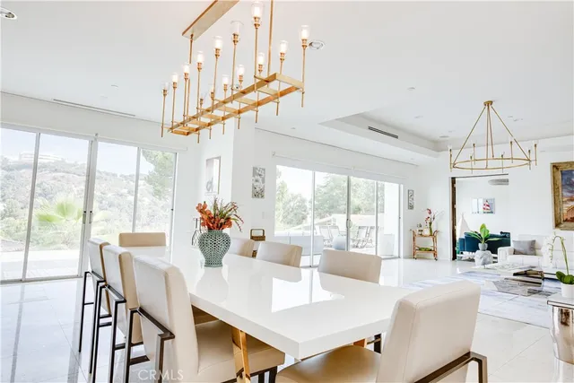 a view of a dining room with furniture large windows and wooden floor