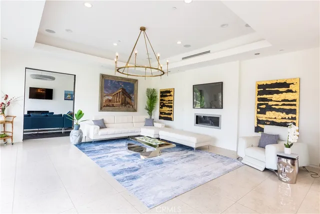 a living room with furniture and a chandelier