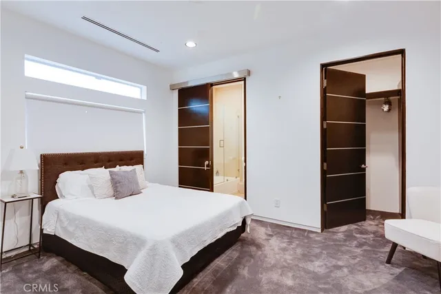 a bedroom with a bed and a closet