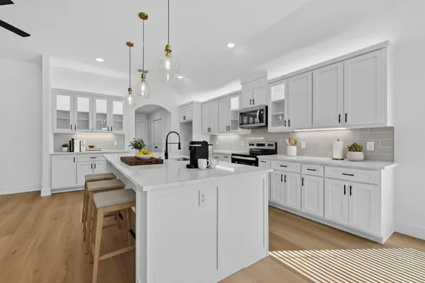 a kitchen with counter top space a sink cabinets and appliances