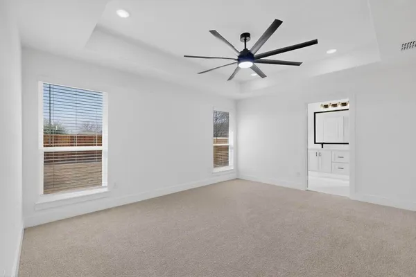 a view of a livingroom with a ceiling fan and window