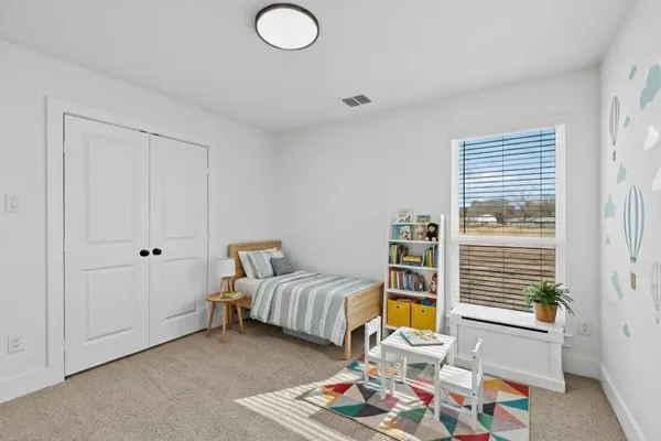 a bedroom with furniture and a window