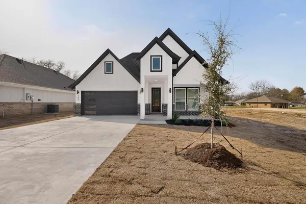 a front view of a house with a yard and garage