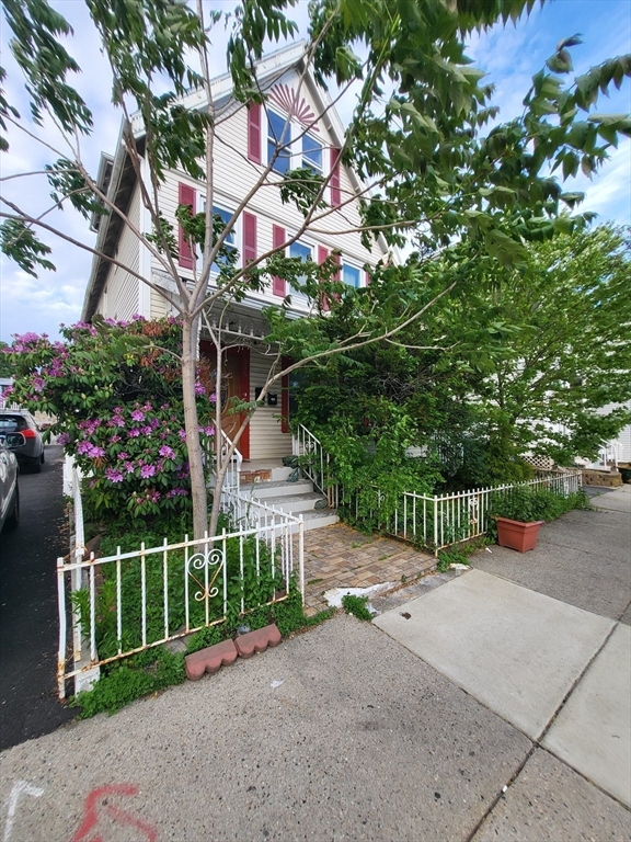 a front view of a house with a garden