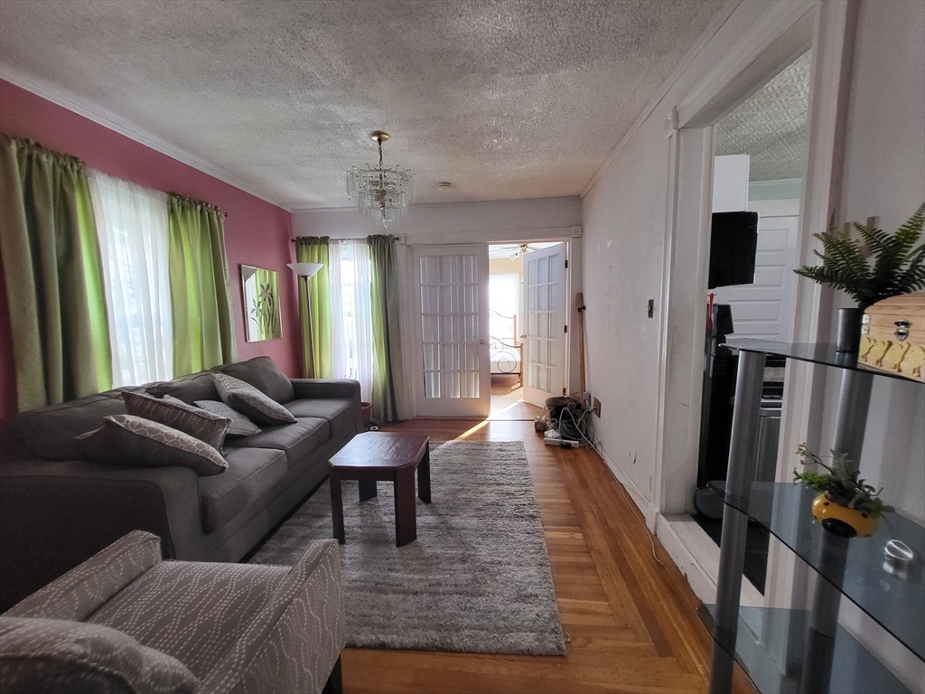 315 Main Street Everett, MA 02149 - Photo 14 of 37 a living room with furniture and a flat screen tv