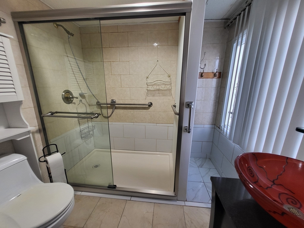 315 Main Street Everett, MA 02149 - Photo 18 of 37 a bathroom with a toilet and a shower