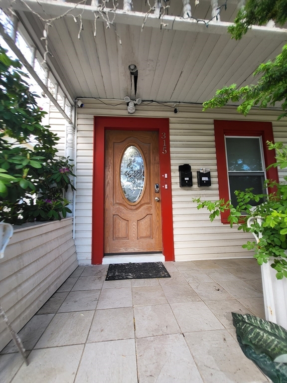 315 Main Street Everett, MA 02149 - Photo 2 of 37 a front view of a house with garden