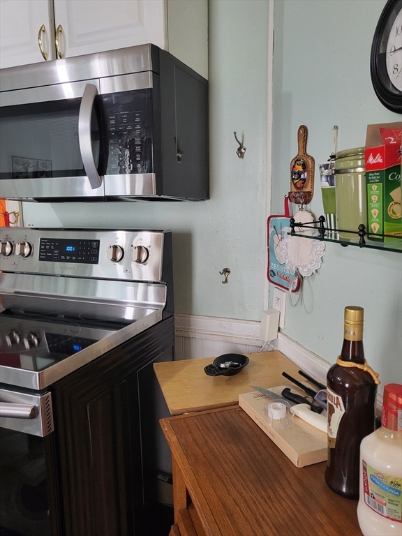 315 Main Street Everett, MA 02149 - Photo 24 of 37 a kitchen with a stove and cabinets