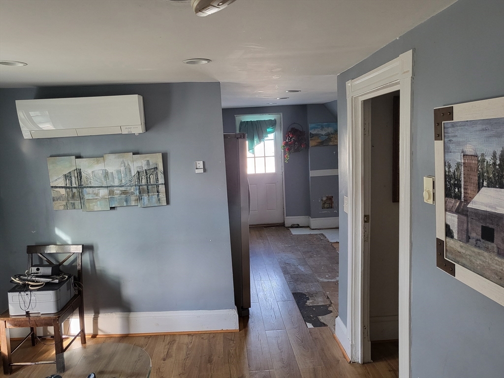 315 Main Street Everett, MA 02149 - Photo 27 of 37 a view of a hallway with wooden floor and a living room