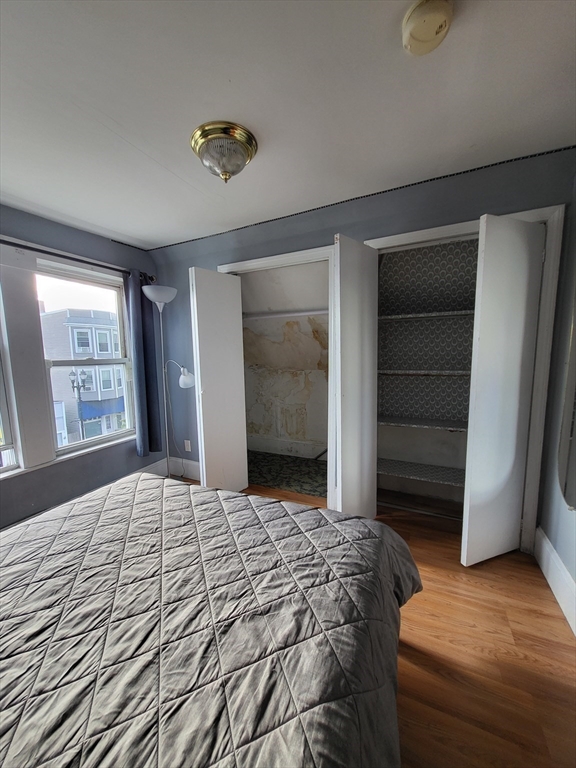 315 Main Street Everett, MA 02149 - Photo 31 of 37 a bedroom with a bed and a dresser